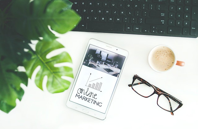 ipad with online marketing plan on a desk with glasses and coffee